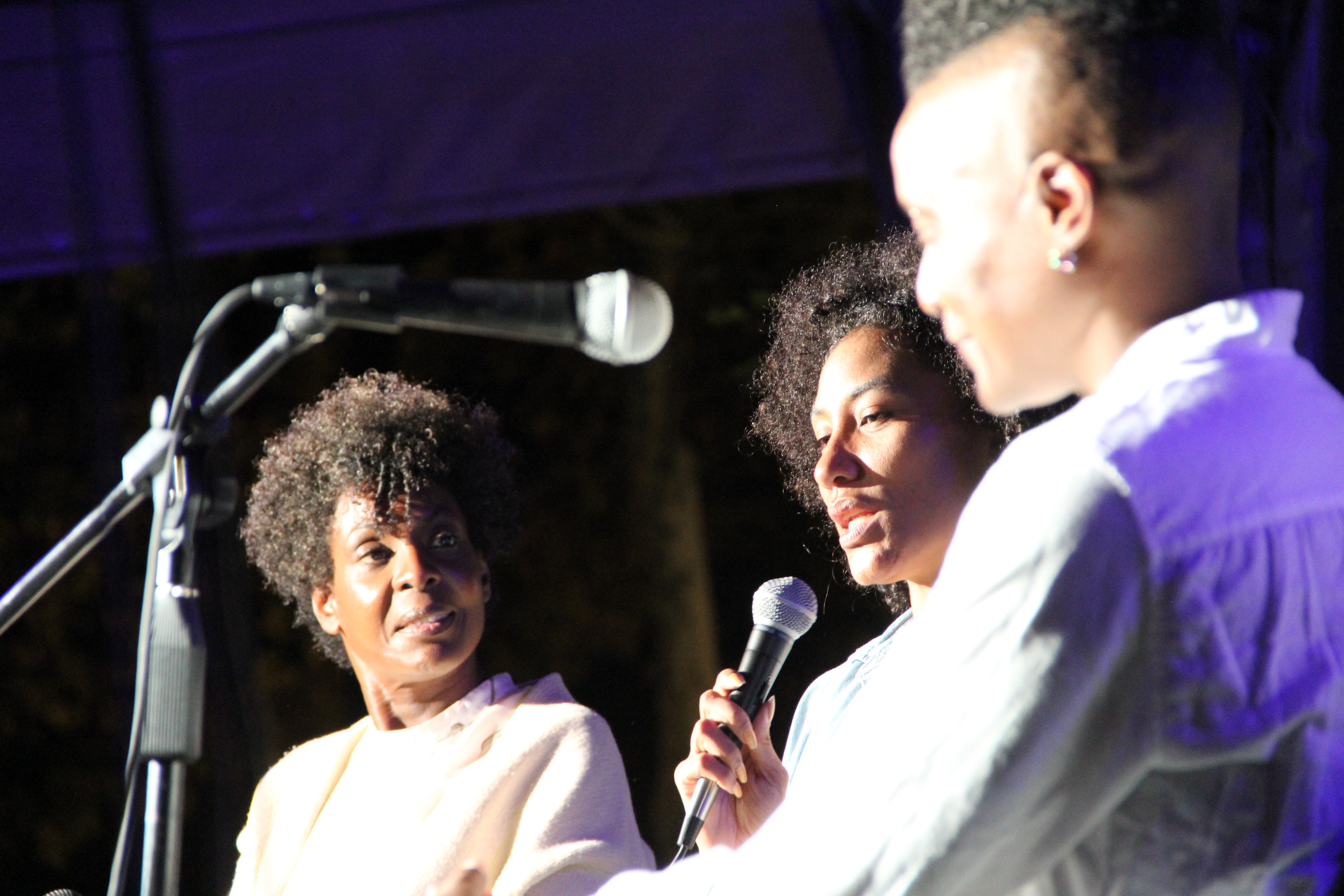 Helga Davis, Naima Ramos-Chapman, and Pitt's Dawn Lundy Martin seated on Schenley Plaza stage. 